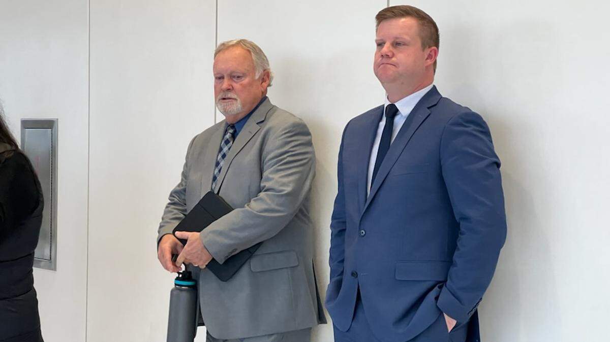 Deputy Justin Wall stands with his father, Lydell, outside of court in Stockton on Monday, Dec. 13, 2021, right after the verdict was announced.