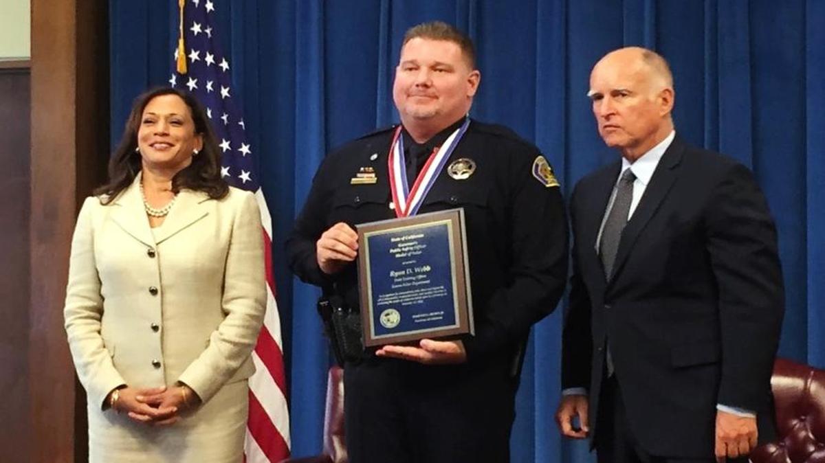 
Sonora police Officer Ryan D. Webb, center, receives the Public Safety Medal of Valor from Gov. Jerry Brown and Attorney General Kamala Harris during a ceremony Monday in Sacramento.
