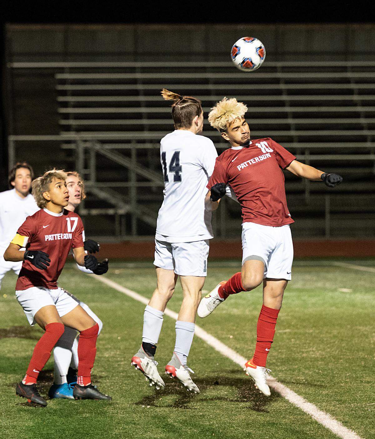 Patterson’s Jonathan Gallardo and Vista del Lago’s James Shull (14) jump for a header during the Sac-Joaquin Section Division III title game at Turlock High School in Turlock, Calif., on Tuesday, Feb. 22, 2022. Vista del Lago (Folsom) won the championship 2-0.