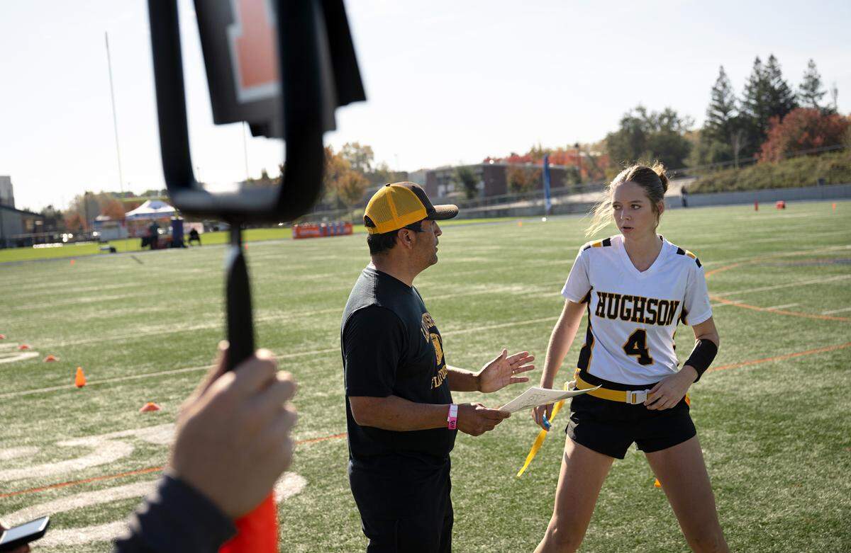Hughson coach Charly Garza talks with quarterback Leah Hobby during the Sac-Joaquin Section Division 4 championship game with Colfax at Cosumnes River College in Sacramento, Saturday, Nov. 9, 2024. Hughson won the game 26-13.