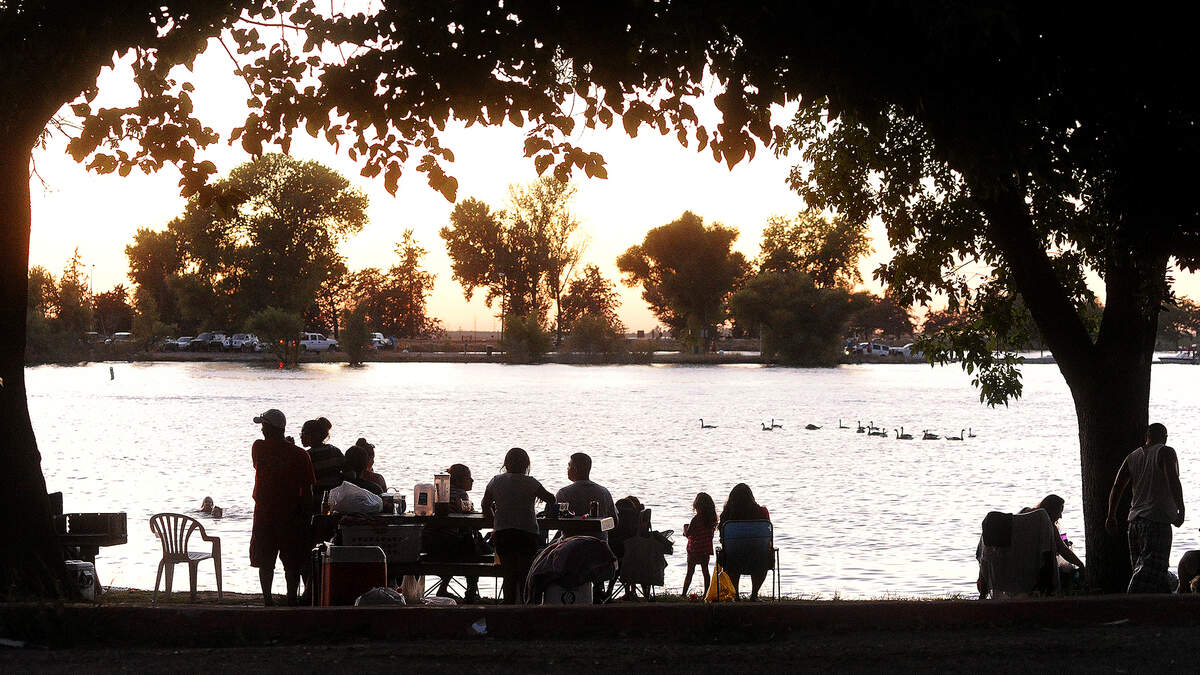 People take in the sunset along Woodward Reservoir.