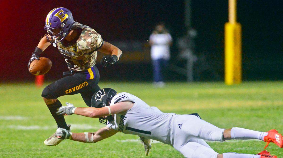Escalon’s Logan Anderson runs past a diving defender during a game between Escalon and Windsor at Escalon High School in Escalon California on September 2, 2022.