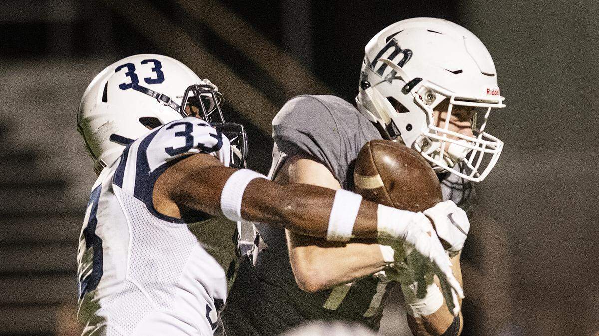 Modesto’s Lucas Curtis makes a catch as American River College defender Jamie Cousey during the CCCAA NorCal Regional Semifinal game with American River College at Modesto Junior College in Modesto, Calif., Saturday, Nov. 23, 2019. Modesto won the game 35-28.