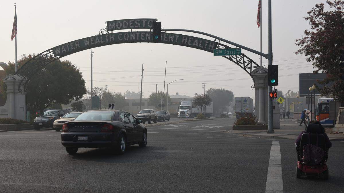 Smoke from the distant Camp Fire in Butte County hangs over downtown Modesto, Calif., on Nov. 16, 2018.