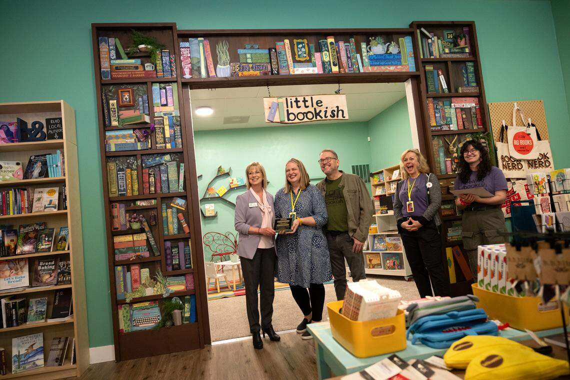 Bookish owners Paula Treick DeBoard and Will DeBoard are presented with a plaque by Modesto Chamber of Commerce president Trish Christensen during a grand opening ceremony of the bookstore in Roseburg Square in Modesto, Calif., Tuesday, April 4, 2024.