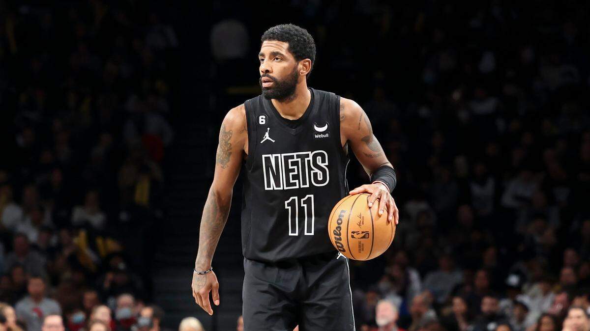 Brooklyn Nets guard Kyrie Irving (11) dribbles down the court during the second half of an NBA basketball game against the Milwaukee Bucks, Friday, Dec. 23, 2022, in New York. (AP Photo/Jessie Alcheh)