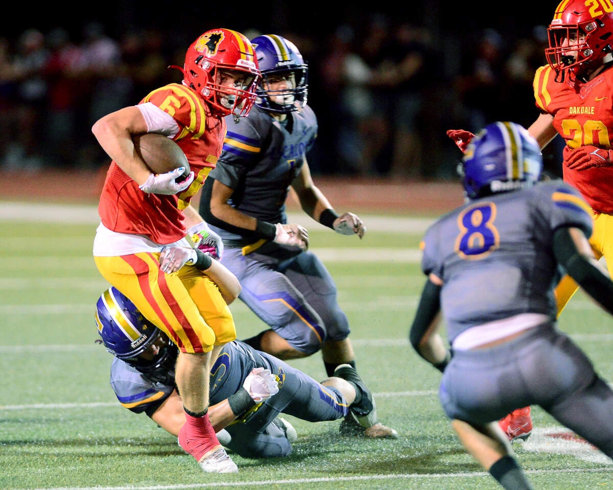 Oakdale running back Chase Lopez (6) cuts through the defense during a game between Oakdale and Escalon at Oakdale High School in Oakdale, California, on September 15, 2023.