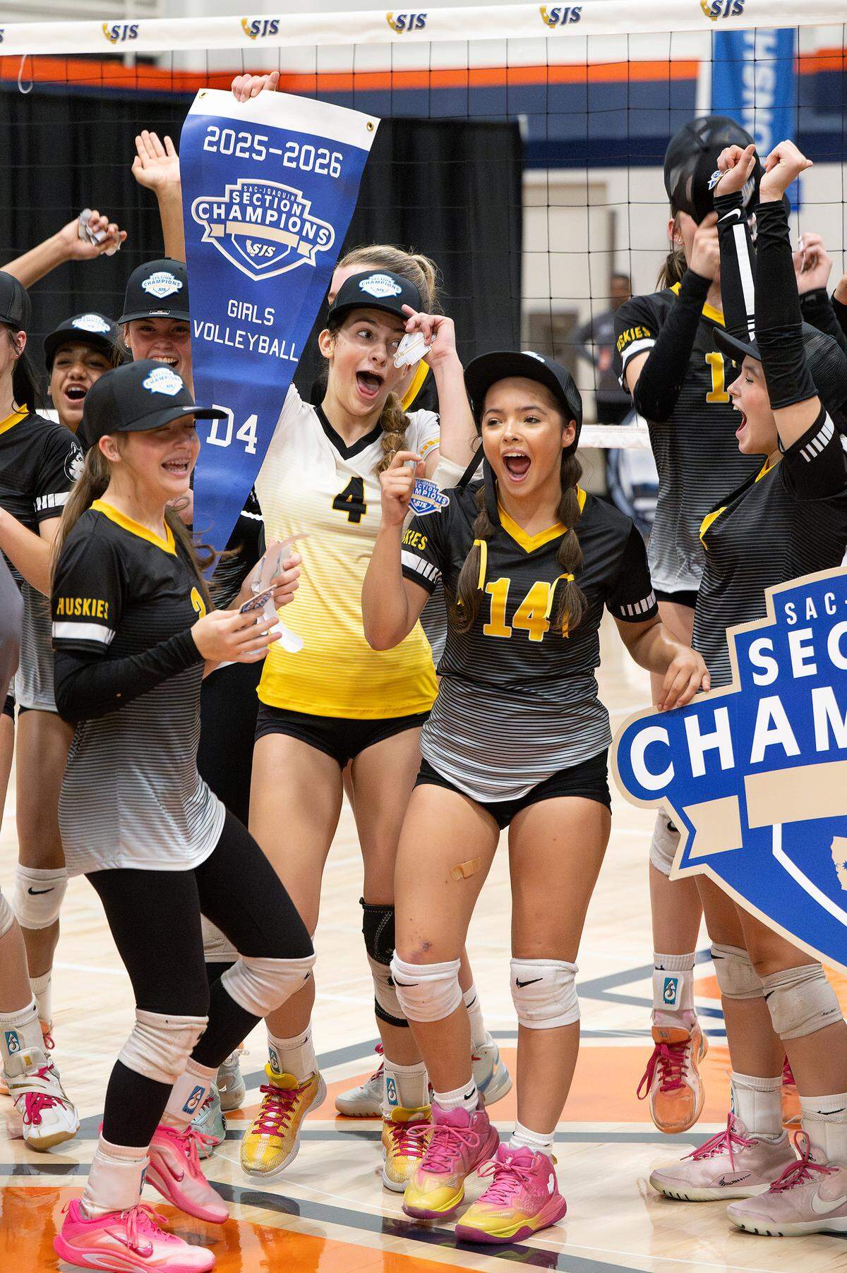 Hughson players celebrate their Sac-Joaquin Section D4 volleyball championship win at Cosumnes River College in Sacramento, Saturday, Nov. 8, 2025.