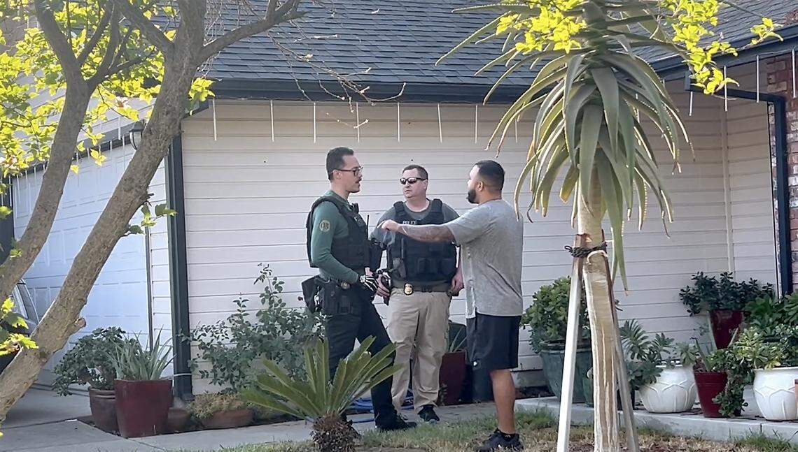 In a screen capture from video, a man speaks to armed agents outside a Modesto home on Sept. 11, 2025.