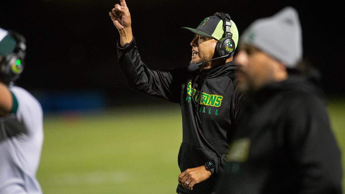 Davis coach Tim Garcia directs his team during the Western Athletic Conference game with Lathrop at Modesto Junior College in Modesto, Calif., on Friday, Oct. 8, 2021. Davis won the game 25-13.