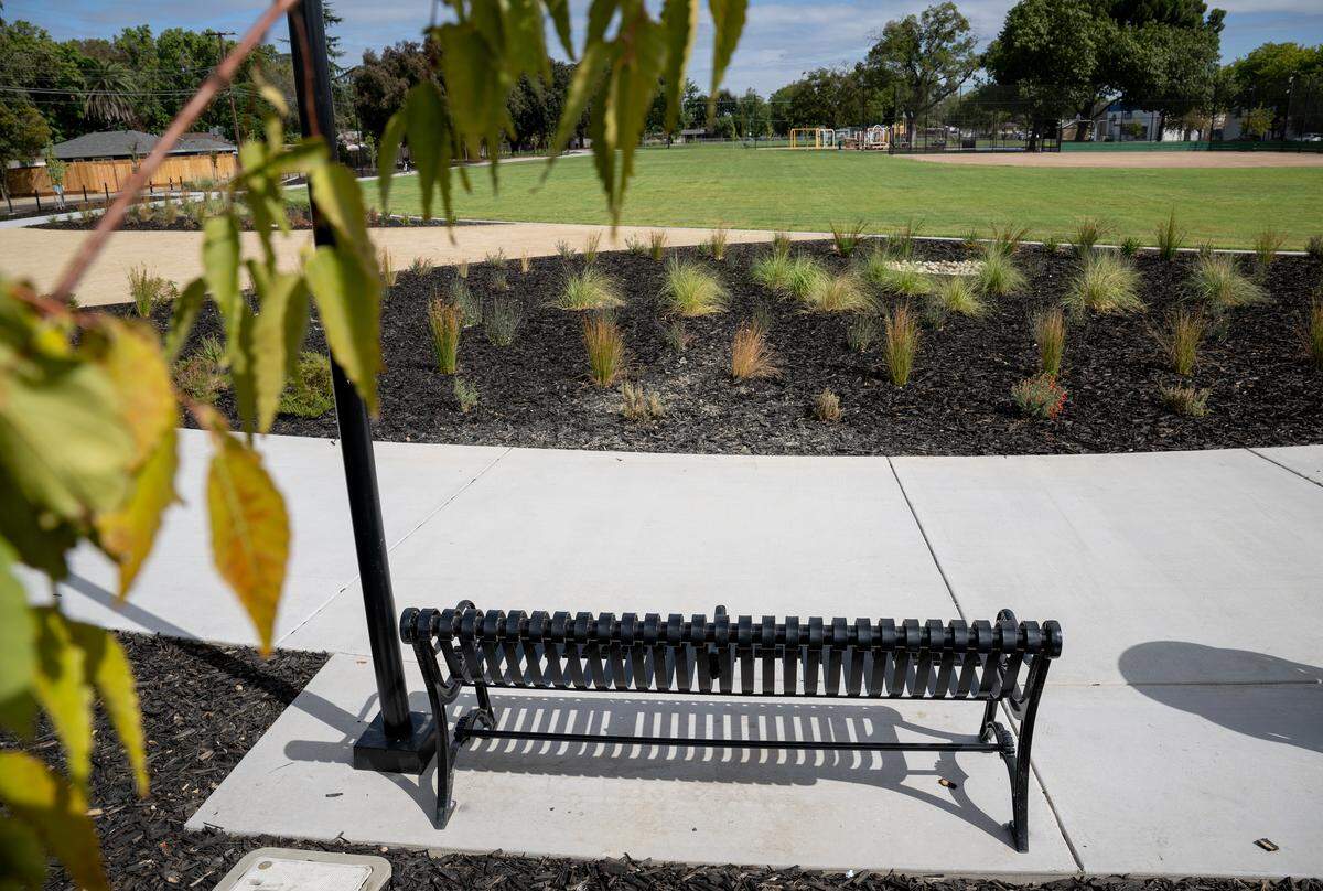 Bench seating along a pedestrian path at Pike Park in Modesto, Wednesday, Oct. 1 2025.