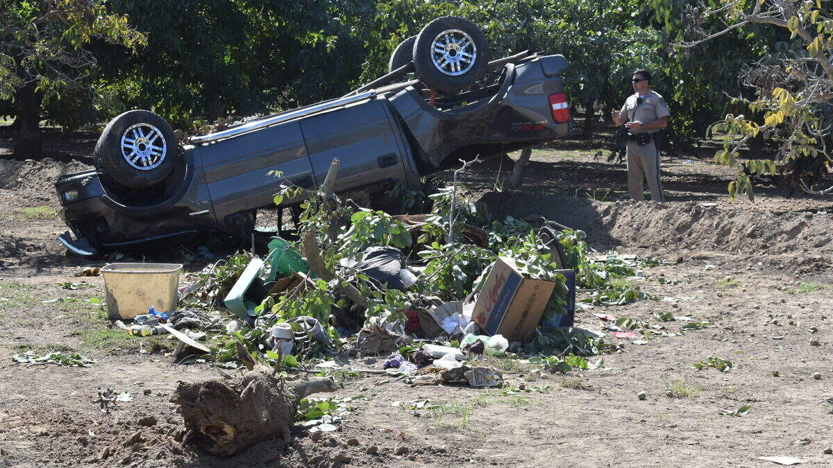 The California Highway Patrol investigates a fatal, single-vehicle crash into a walnut orchard on the 3800 block of Paradise Road southwest of Modesto on Sunday afternoon, Sept. 29, 2019. The tubs, patio furniture and other belongings strewed on the ground came from the bed of the pickup truck.