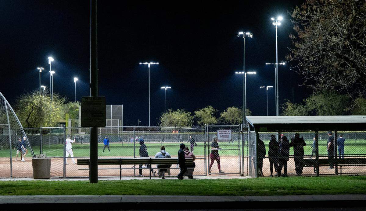 Adults play in a co-ed softball league under new LED lights at Pedretti Park in Turlock, Calif., Thursday, March 28, 2024.
