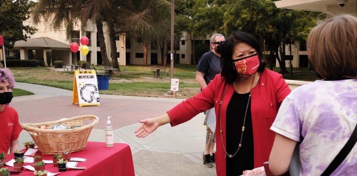 California State University, Stanislaus, President Ellen Junn offers students succulents as a housewarming gift on move-in day last week.