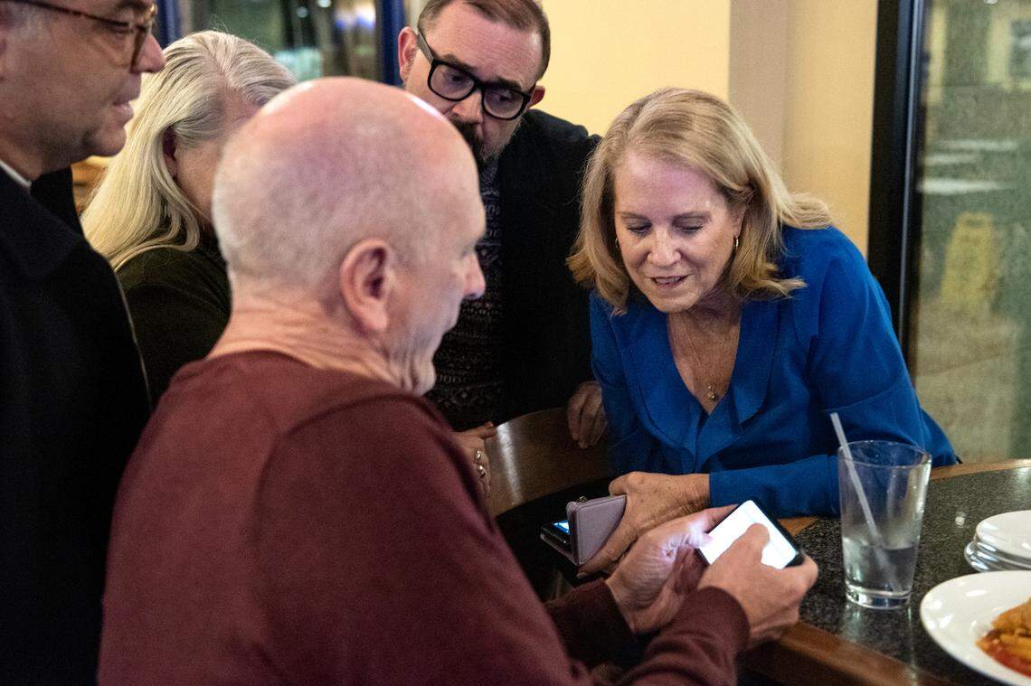 Modesto Schools superintendent Sara Noguchi, right, and board member Chad Brown, left, look at early results for Measure L at Fuzio restaurant in Modesto Calif., Tuesday, Nov. 8, 2022.