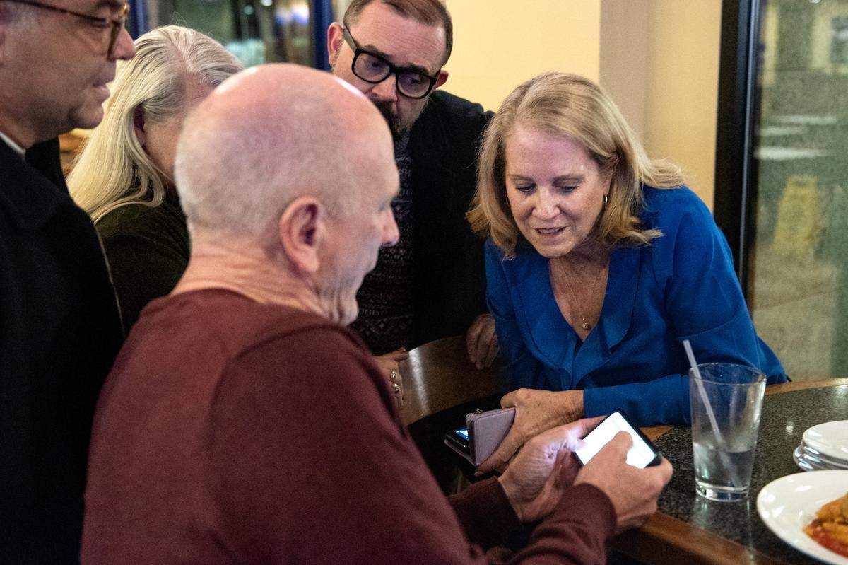 Modesto Schools superintendent Sara Noguchi, right, and board member Chad Brown, left, look at early results for Measure L at Fuzio restaurant in Modesto Calif., Tuesday, Nov. 8, 2022.