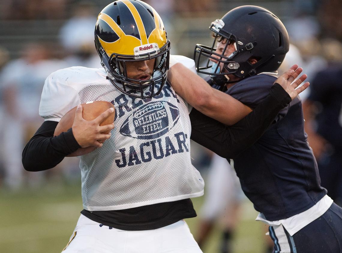 Gregori’s Tony Leatherberry fights off a Downey defender during a preseason scrimmage at Downey High School in Modesto, Calif., Friday, August 10, 2018. 