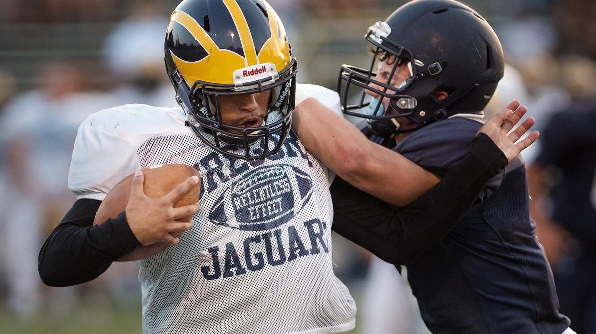 Gregori’s Tony Leatherberry fights off a Downey defender during a preseason scrimmage at Downey High School in Modesto, Calif., Friday, August 10, 2018. 