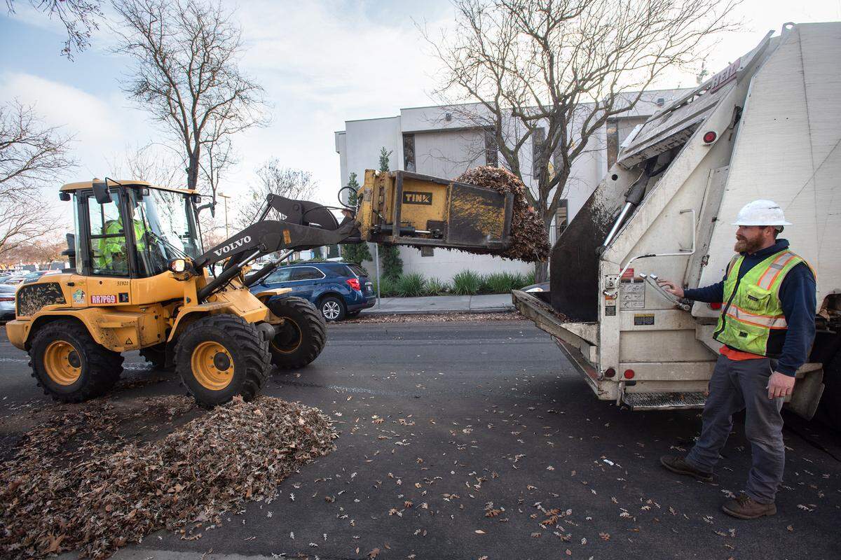 A City of Modesto crew clears leaf piles in Modesto, Calif., Thursday, Dec. 22, 2022.
