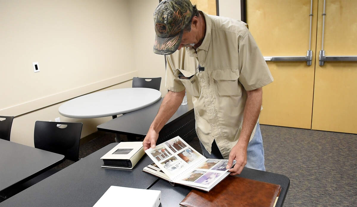Mark Ranzo looks through a photo album with pictures of his parents, Kathy and Phillip Ranzo. In 1979, when Mark was 10 years old, his parents were murdered in their Modesto home. Ronald Ray Anderson, involved in the killings, was granted parole during a Dec. 28, 2021, hearing. Gov. Gavin Newsom could still overturn it. The family gathered at the Stanislaus County District Attorney’s Office in downtown Modesto to make a plea to the governor to overturn the decision of the parole board. Photographed in Modesto, Calif., on Friday, March 11, 2022.