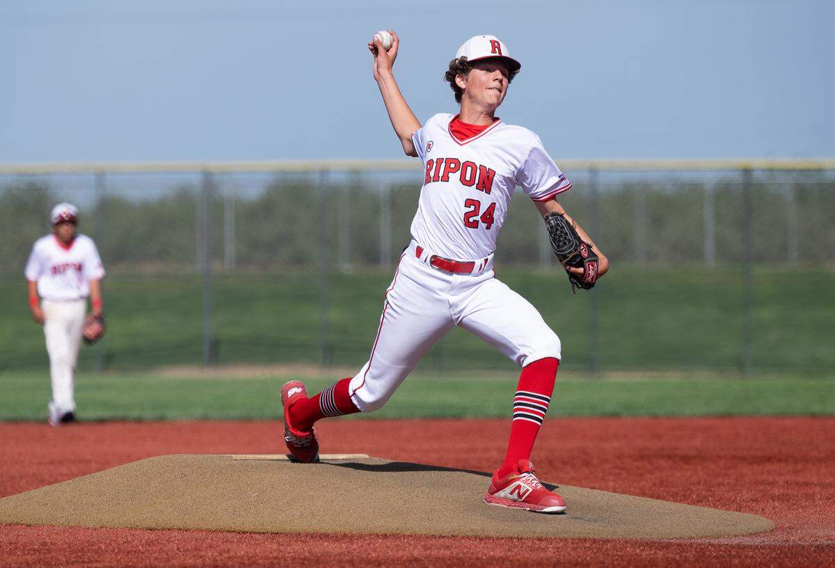 Ripon’s Dawson Downs delivers a pitch during the Trans Valley League game with Hughson at Mistlin Park in Ripon, Calif., on Wednesday, April 27, 2022. Ripon won the game 11-1.