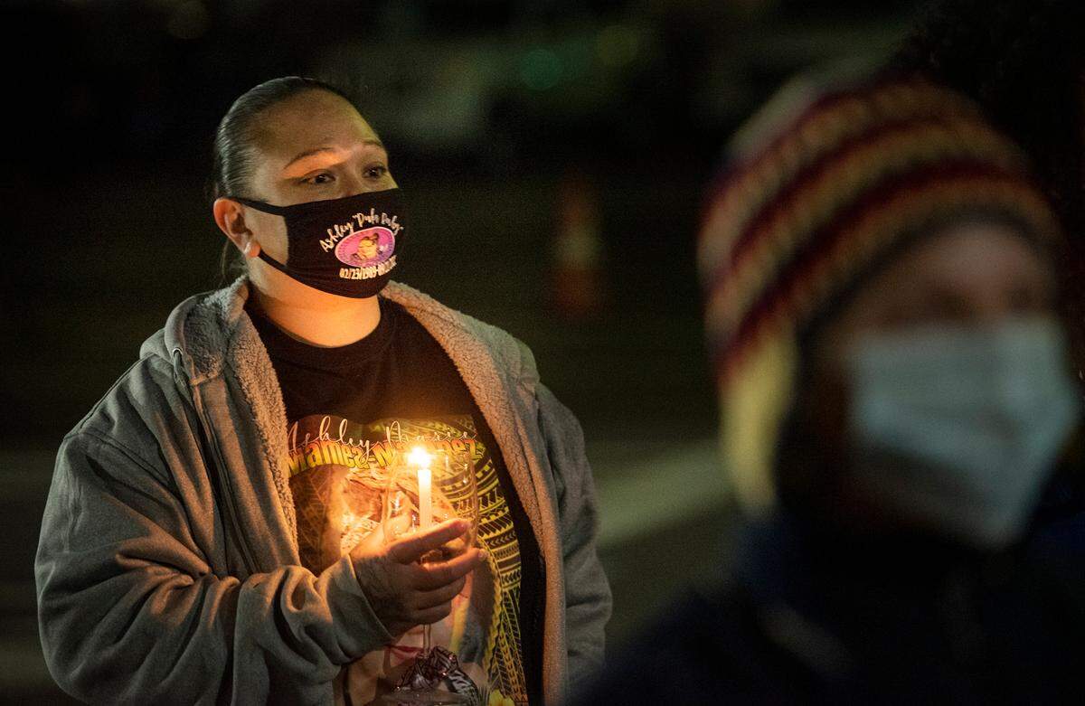Abigail Mendoza listens to music during the annual Modesto vigil honoring people who died while experiencing homelessness in Stanislaus County. A small group remembered those who died in both 2020 and 2021 during a ceremony at The Salvation Army Berberian Shelter in Modesto, Calif., on Tuesday, Dec. 21, 2021. The event occurred on National Homeless Persons’ Memorial Day, which marks the winter solstice and longest night of the year.