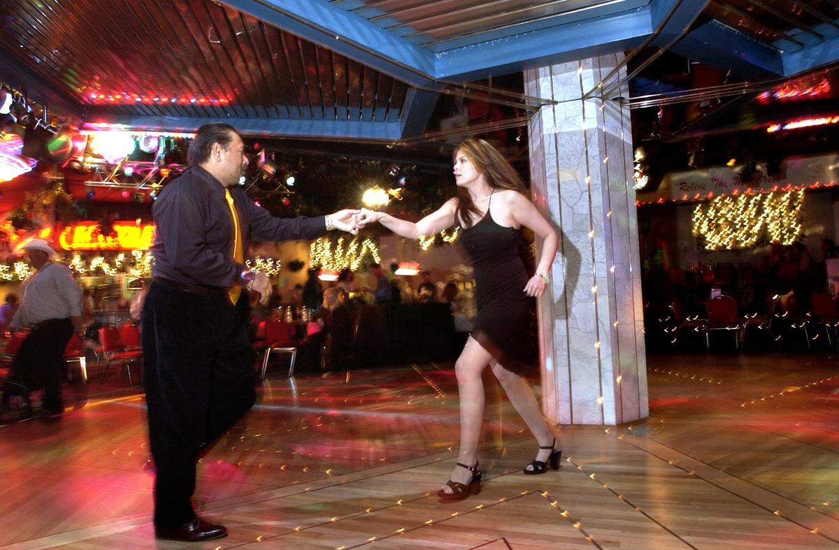 At left, Modesto resident Gilbert Vasqsuez dances with Modesto resident Martha Iverson at Crocodiles night club Friday night. (03/14/2003 - Adrian Mendoza / The Modesto Bee).