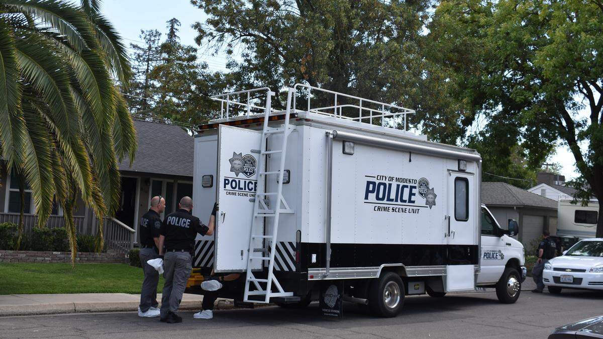 Modesto Police Department Crime Scene Unit members prepare to enter a home on the 800 block of Columbia Way in the neighborhood east of Modesto Junior College on Sunday, Sept. 22, 2019.
