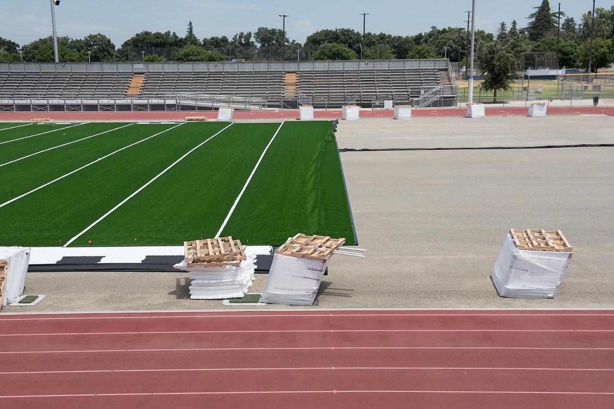 New artificial turf is being installed at Joe Debely Field at Turlock High School in Turlock, Calif., Friday, July 13, 2018. 
