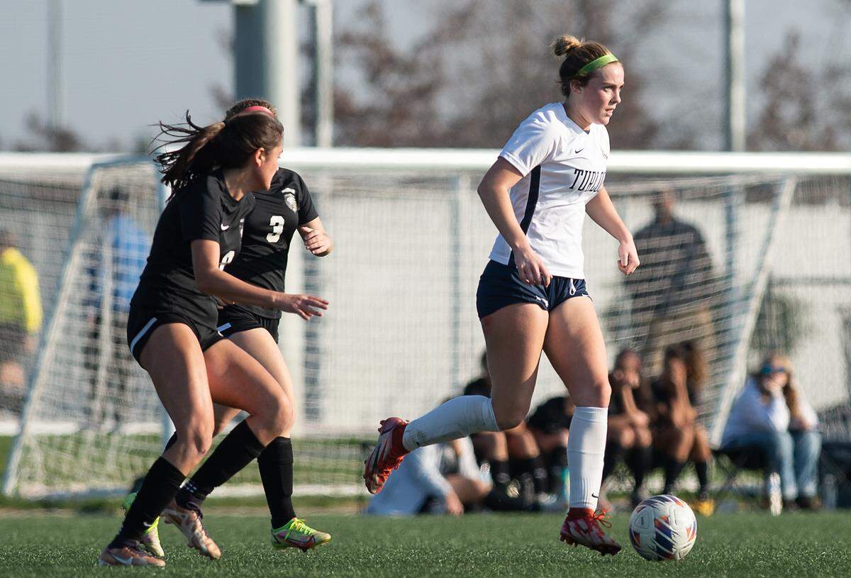 Turlock’s Jenna Dean moves the ball up the field during a Central California Athletic League game with Enochs at Mary Grogan Park in Modesto, Calif., Wednesday, Jan. 25, 2023.