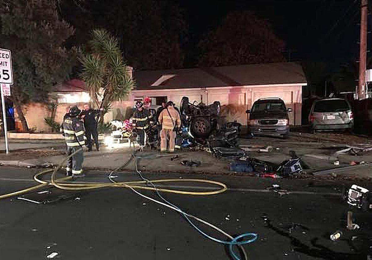 Firefighters work the scene of a fatal crash that took the lives of Megan and Sherri Cooley, who were killed when the vehicle they were in was struck by a speeding Mercedes on Tully Road in Modesto, California, on Wednesday, Nov. 29, 2017.