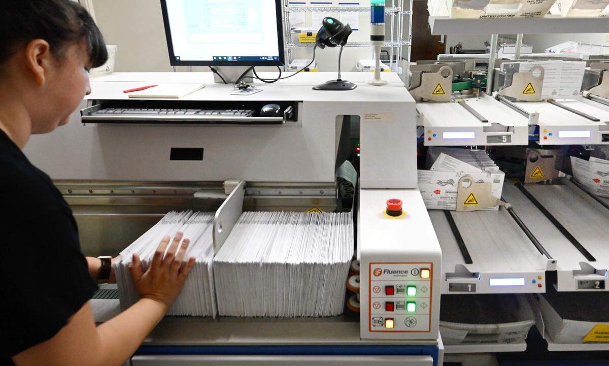 Supervisor Karina Cortez loads ballots into the signature scanning machine at the Stanislaus County Registrar of Voters office in Modesto, Wednesday, Oct. 23, 2024.