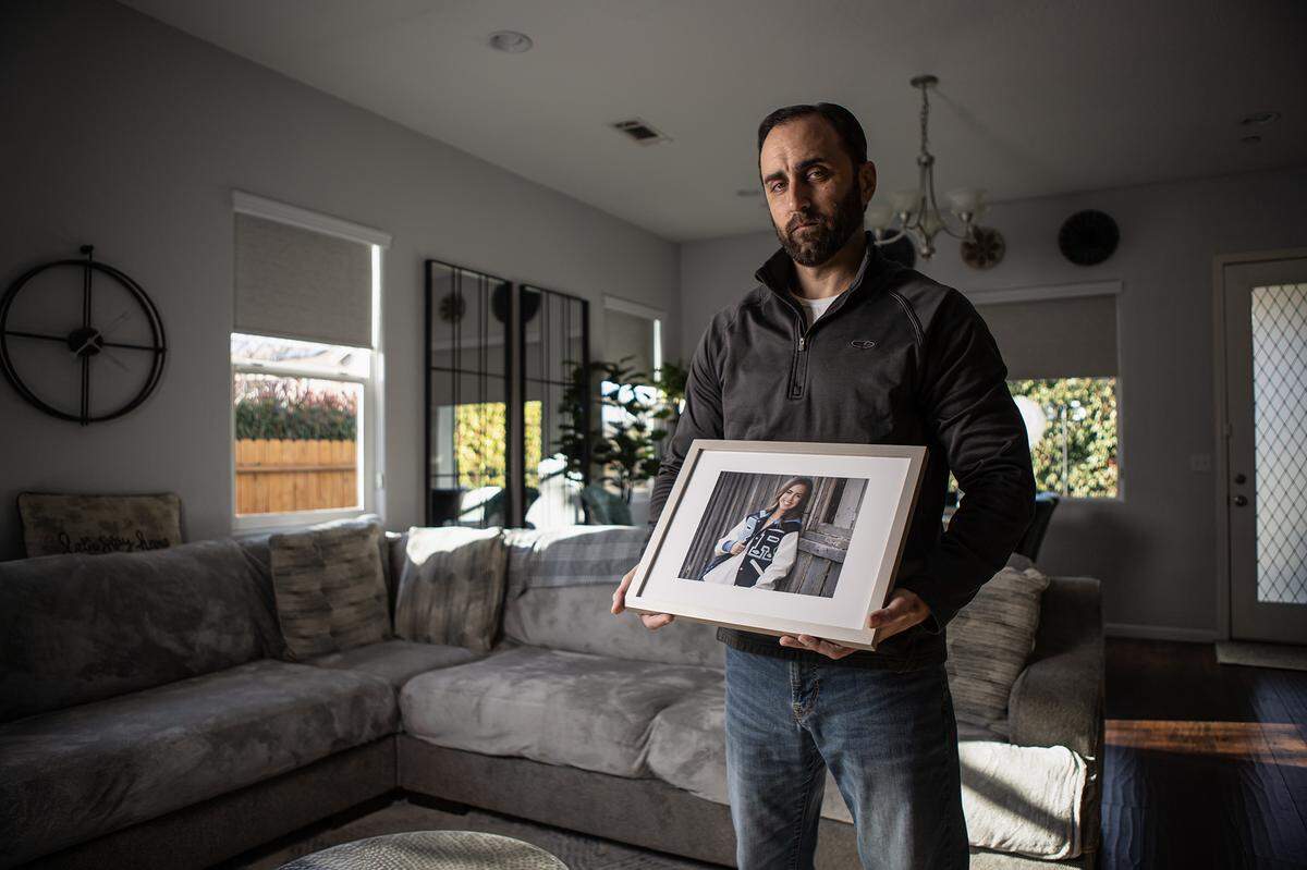 Jerrod Tejeda holds a framed photo of his daughter Cassi Tejeda, at his home in Visalia on March 6, 2025. Cassi was killed by a drunk driver with two prior DUIs in January of 2022.