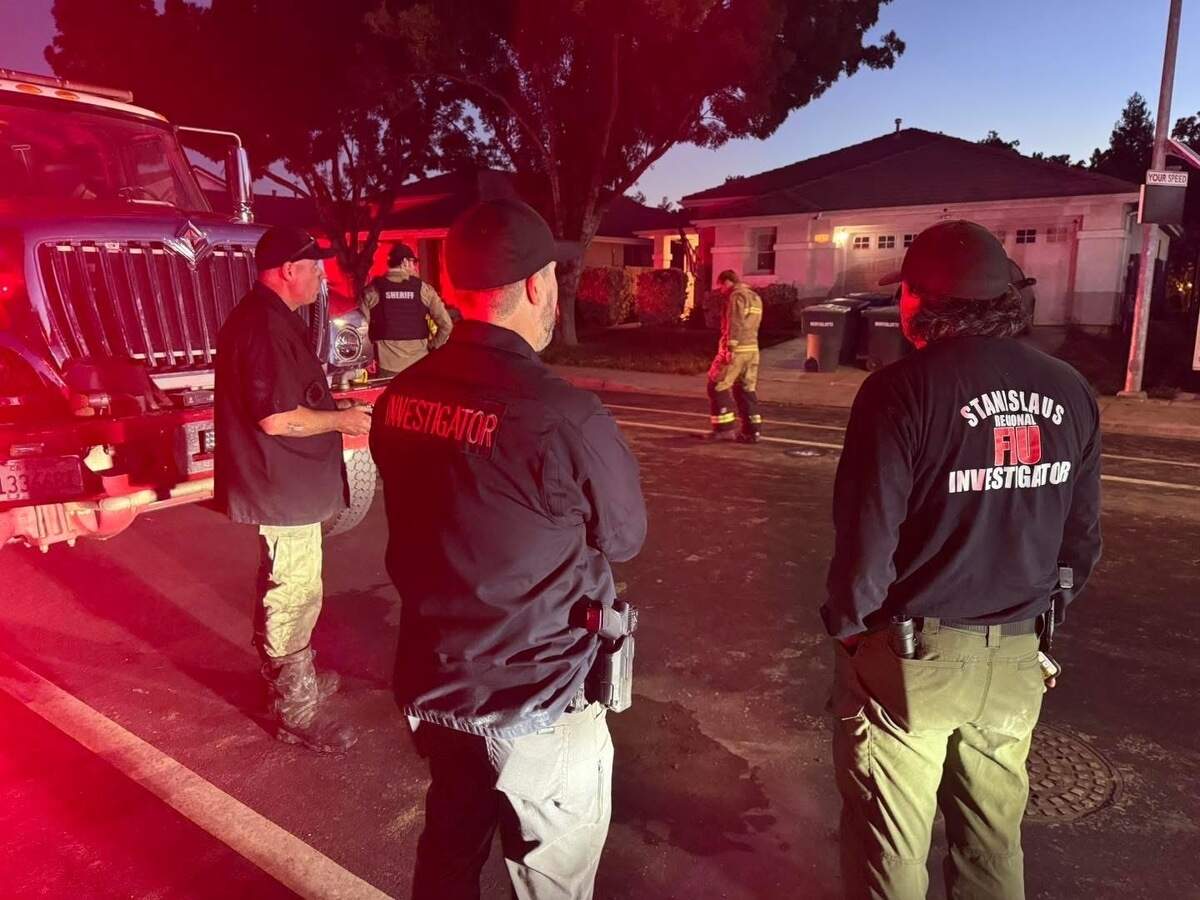 Fire investigators with the Stanislaus Regional Fire Investigation Unit and members of the Stanislaus County Sheriff’s Office investigate a fatal residential structure fire Sunday night in Patterson.
