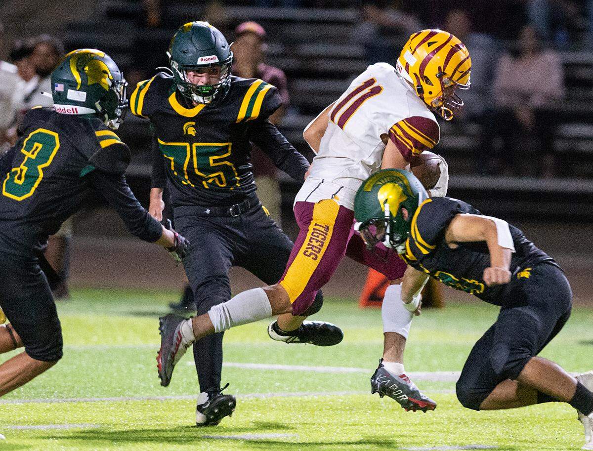 Los Banos’ Mark Carreiro slips past the Davis’ defense on his way to a 71-yard touchdown during a Western Athletic Conference game at Downey High School in Modesto, Calif., on Friday, September 23, 2022. Los Banos won the game 32-17.