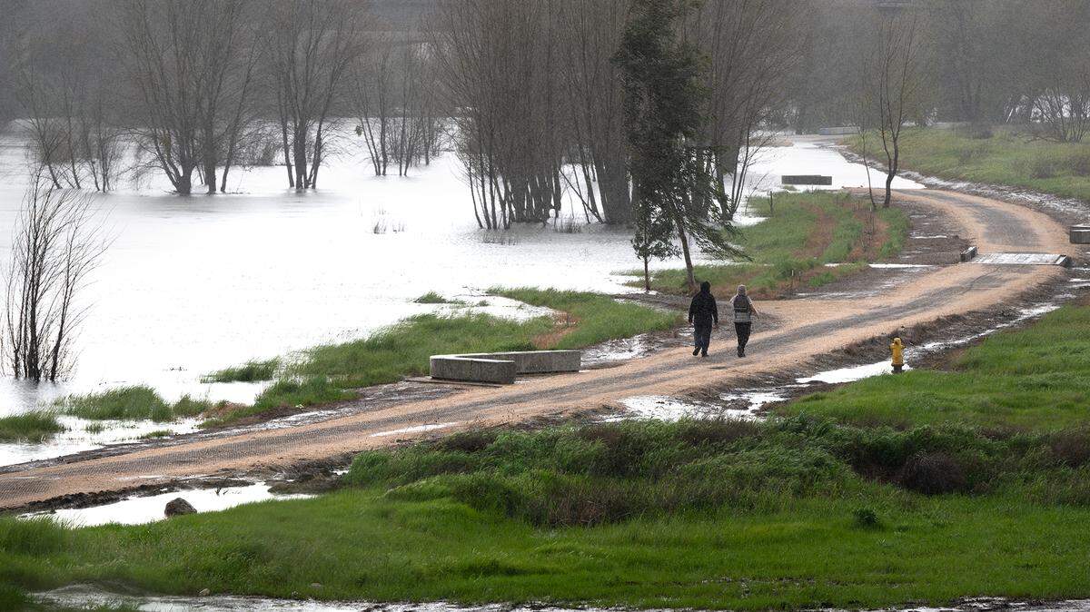 The walking path in the Tuolumne River Regional Park is partially submerged by water from the Tuolumne River in Modesto, Calif., Tuesday, March 21, 2023.