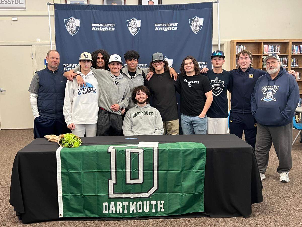Downey High’s Camden Rush poses with members of the Knights baseball team after signing to play shortstop at Dartmouth College on Feb. 2, 2023 in Modesto, Calif.