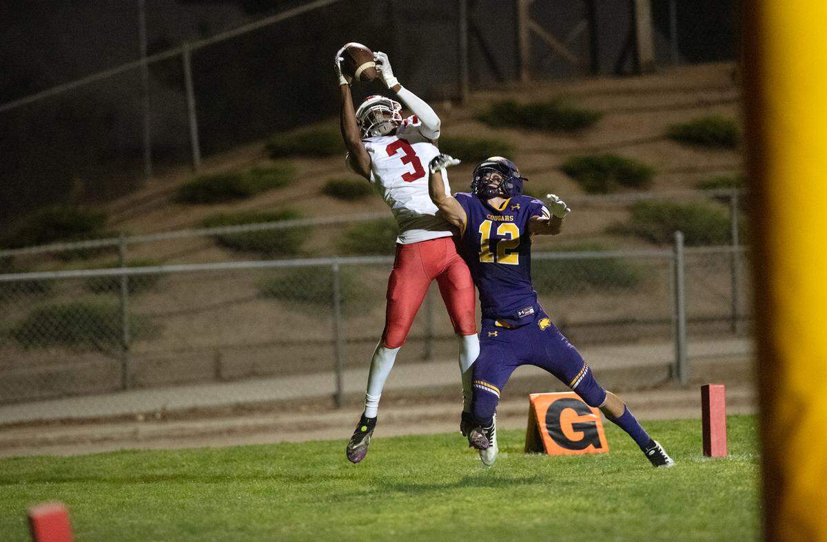 Modesto Christian’s Isaiah Davis makes a touchdown catch over Escalon’s Derek Silva during the Trans-Valley League game in Escalon, Calif., Thursday, Oct. 6, 2022. Escalon won the game 62-30.