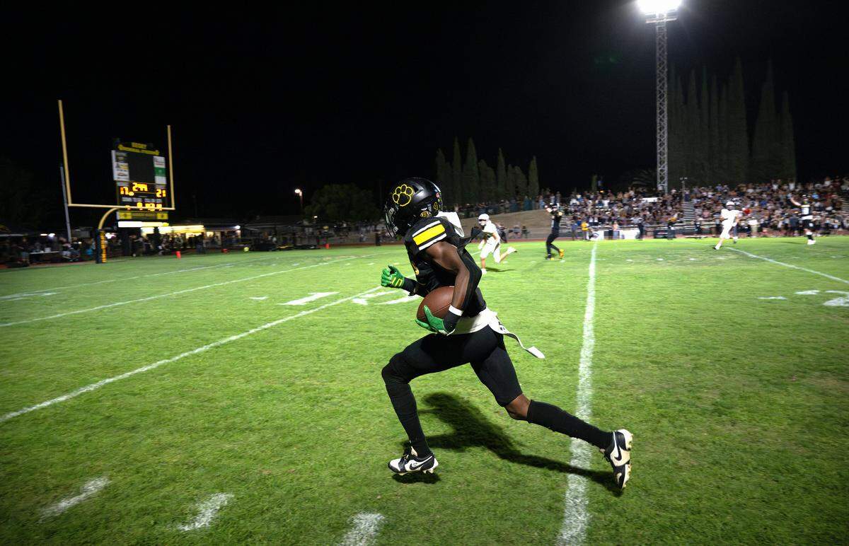 Hughson’s Malakai Sumter runs the ball in for a touchdown after a catch during the Trans Valley League game with Escalon in Hughson, Calif., Friday, Oct. 4, 2024.