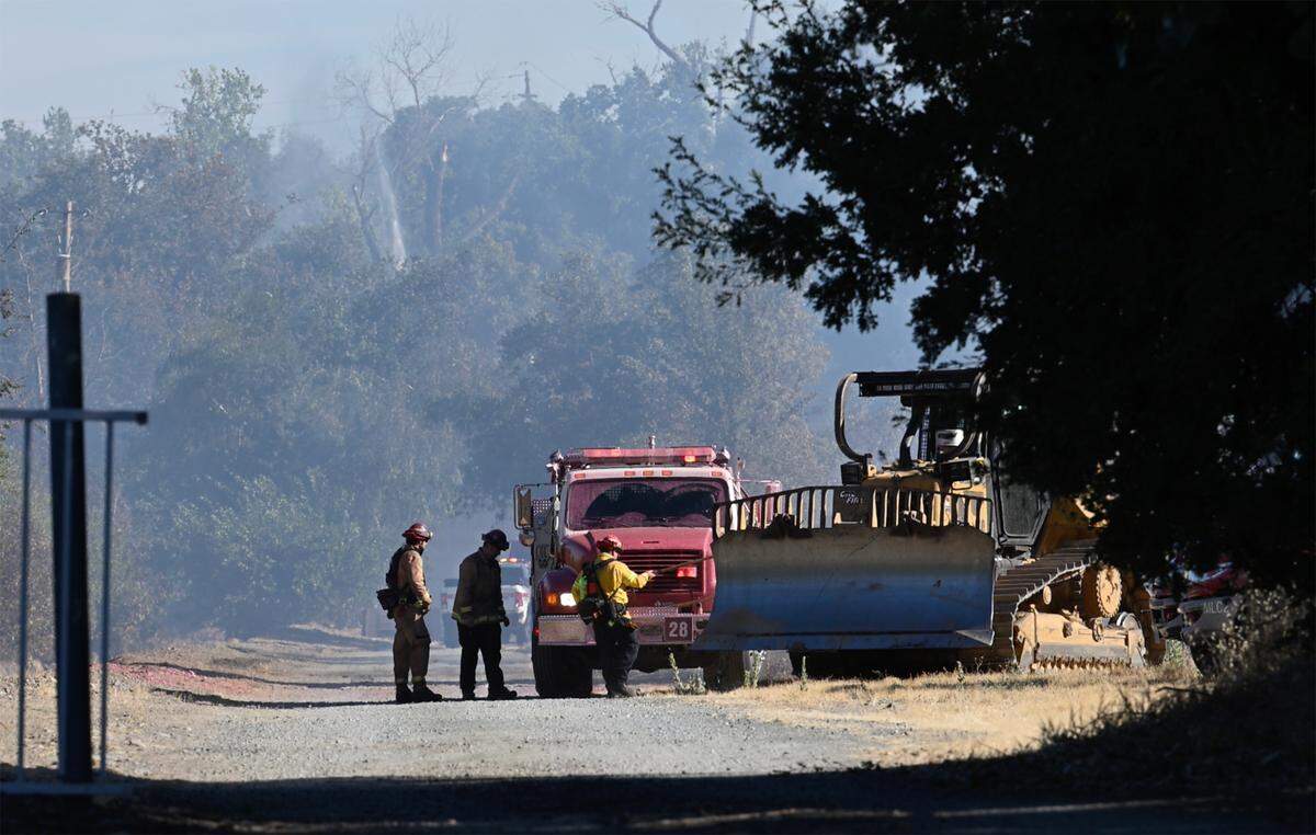 Residents along Orange Blossom Road were evacuated as a grass fire burned 7 acres and damaged property in Oakdale, Calif., Saturday, July 29, 2023.