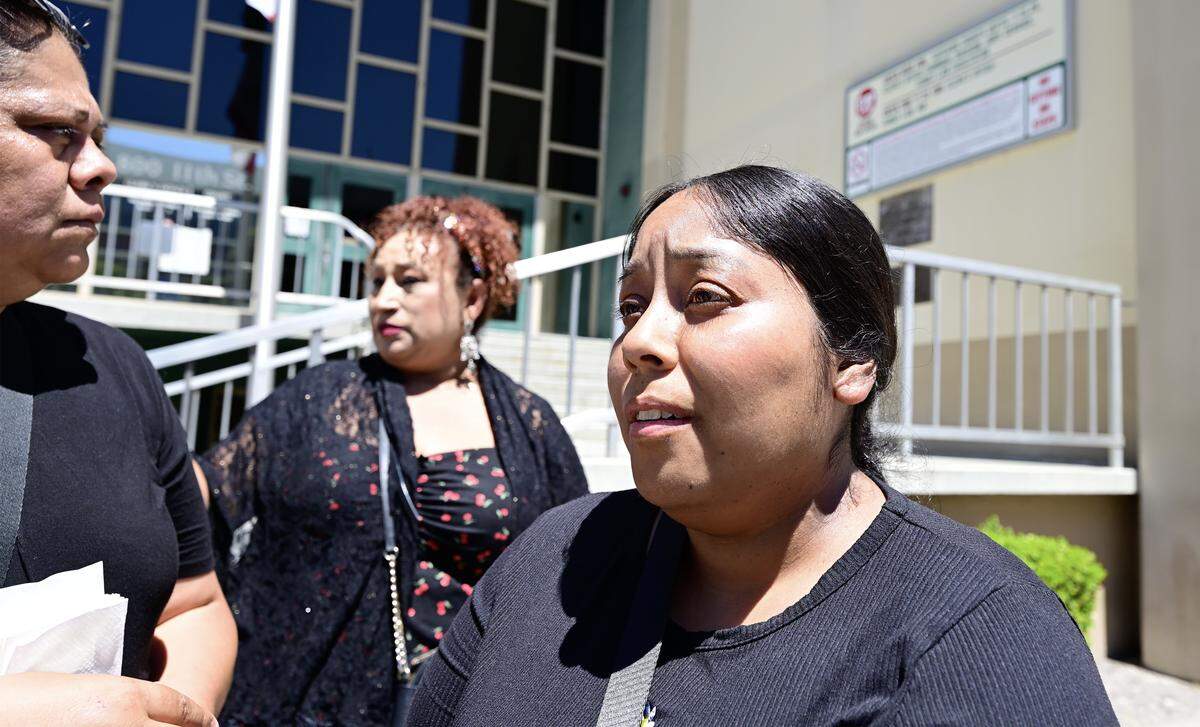 Outside the Stanislaus Superior Courthouse, Sofia Nuñez, right, sister of Maria Silvia Nuñez-Villalobos, speaks to reporters after the arraignment of Joaquin Escoto who pleaded not guilty to the triple-murder of Nuñez-Villalobos, 23-year-old Fabiola Gonzalez-Nuñez, and 2-week-old Mateo Gonzalez.