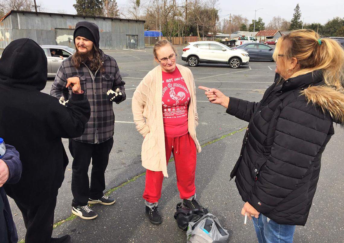 Genesis program clients talk outside the clinic, including Christen Maynard, middle, and Aaron Webster, second from left.