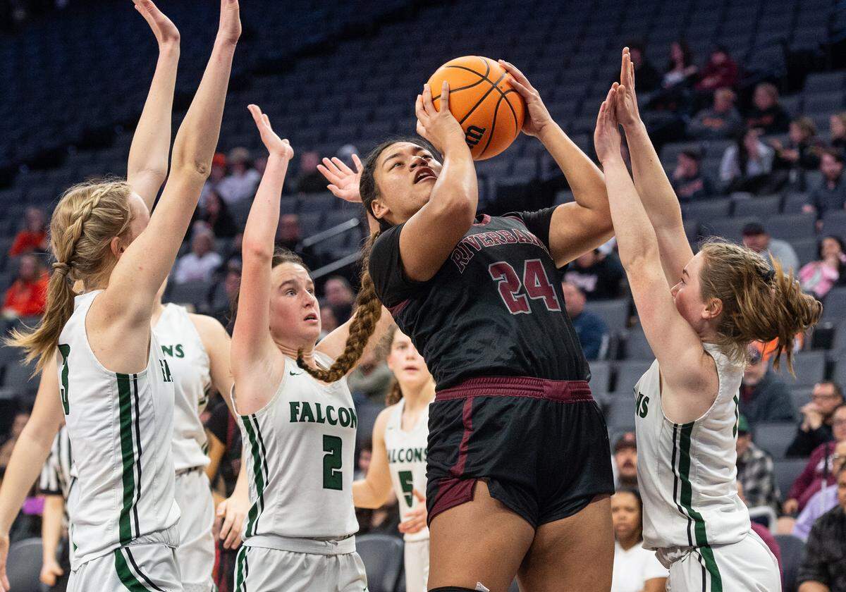 Riverbank’s Rayne Tago scores through a swarm of Colfax defenders during the Sac-Joaquin Section Division IV championship game at Golden 1 Center in Sacramento, Calif., Friday, Feb. 24, 2023.
