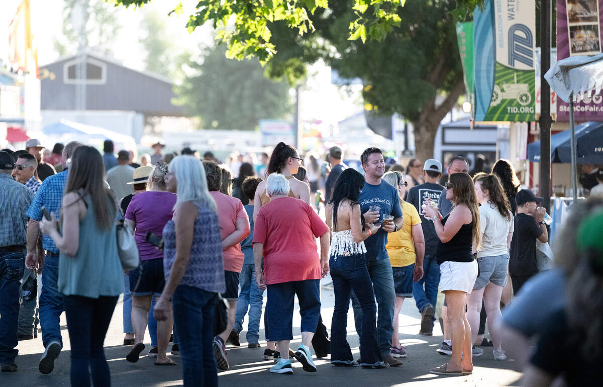 Fair visitors eat and drink at the Stanislaus County Fair in Turlock, Calif., Friday, July 7, 2023.