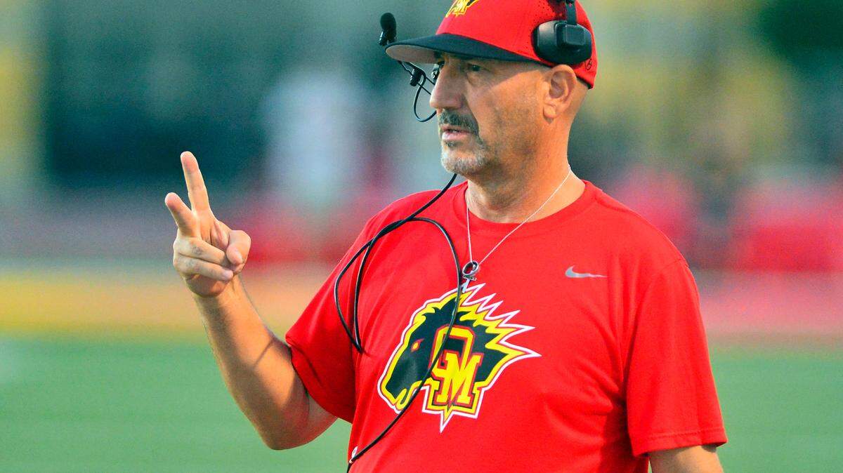 Oakdale Head Coach Trent Merzon motions to the field during a game between Oakdale and Enochs at Oakdale High School in Oakdale CA on September 23, 2022.