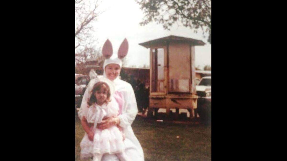 Stacey Rustigian and her little cousin Hillary Hawkins are pictured in front of the family’s birdhouse at her grandparents’ home about 25 years ago, she estimates.