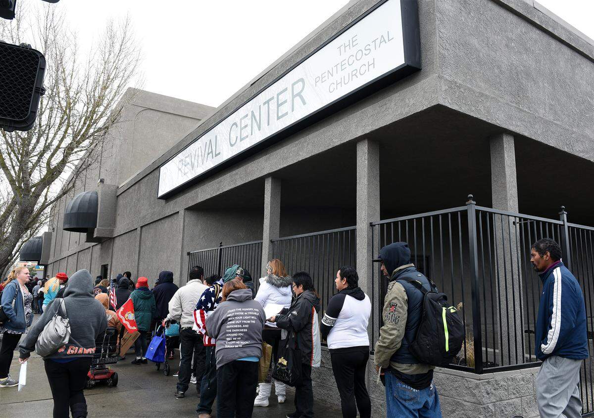 People wait in line on a chilly Monday morning January 22, 2018 at Pentecostal Church in downtown, Modesto, Calif. Second Harvest Food Bank has food giveaway once a month in Modesto. The next one is scheduled for February 12th.