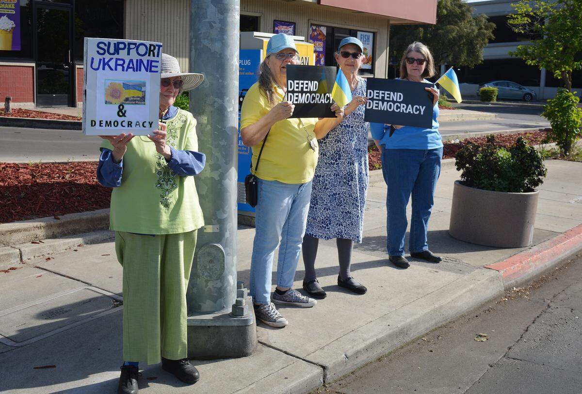 About 50 people gathered at the Five Points intersection for a vigil organized by the Modesto Peace/Life Center.