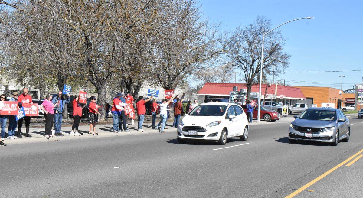Postal workers, former postal workers and their supporters rally along Mitchell Road outside the Ceres post office on Sunday, March 23, 2025.