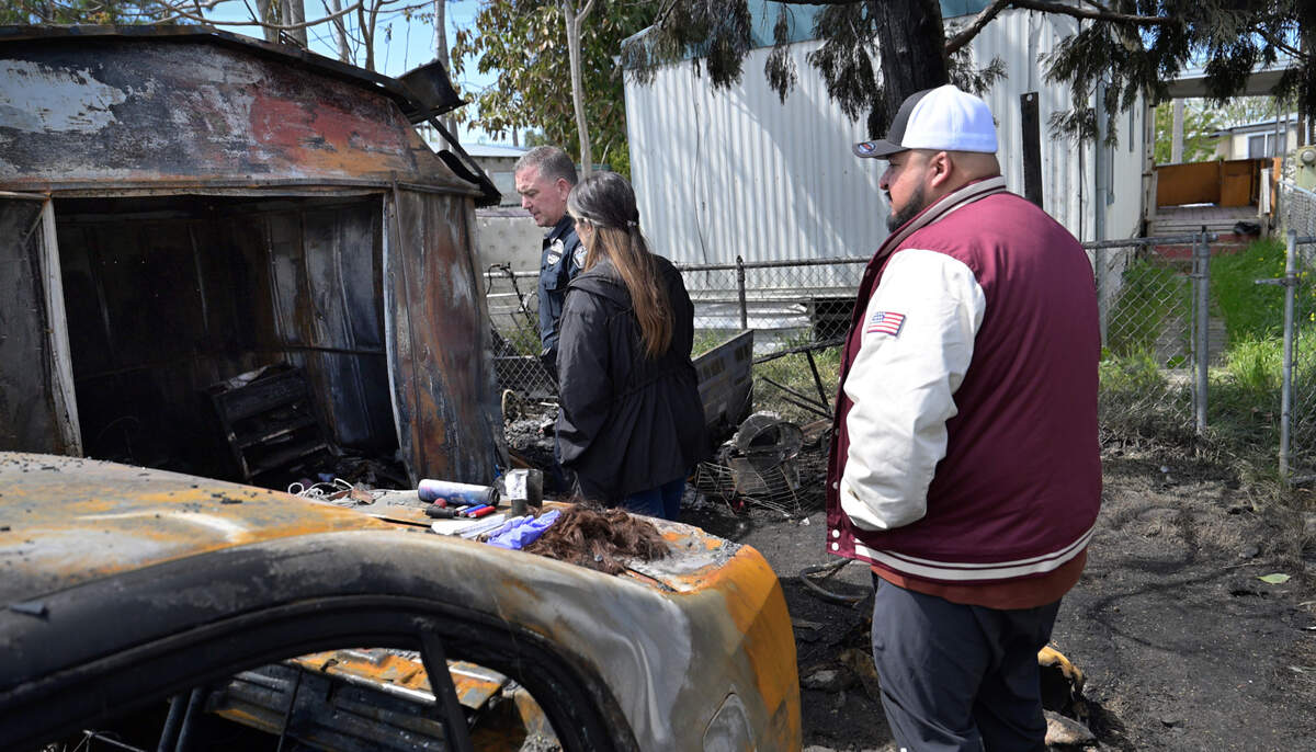 Ceres Police Lt. Jeff Godfrey, Ceres Councilmember Cerina Otero, left, and Ceres Mayor Javier Lopez look at the scene of a deadly fire at the Lazy Wheels mobile home park in Ceres on Wednesday, April 2, 2025.